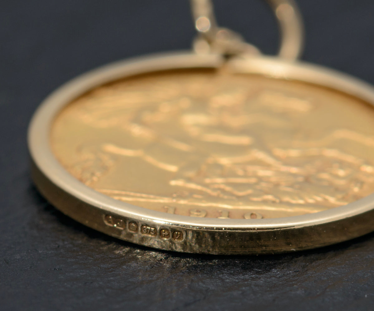A George V 1914 half sovereign, mounted on a yellow metal pendant, on a 9ct  gold chain, total weight
